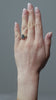 Gold ring with a teardrop-shaped blue diamond  centre stone with round diamonds